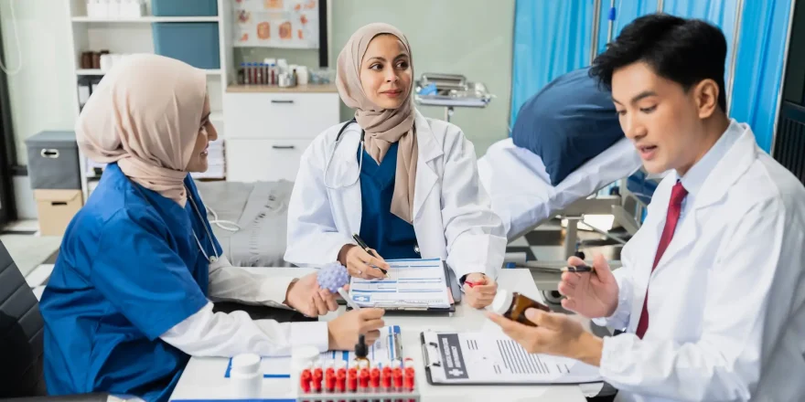 Diversity, medical team head leaders discuss results, brainstorming and planning. Doctor, nurse and computer on desk.
